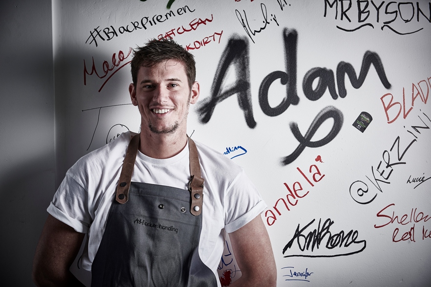 Adam in front of signed wall - Press Image