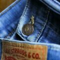 A close-up of classic Levi Strauss & Co. jeans, highlighting their iconic button detail and signature denim texture.