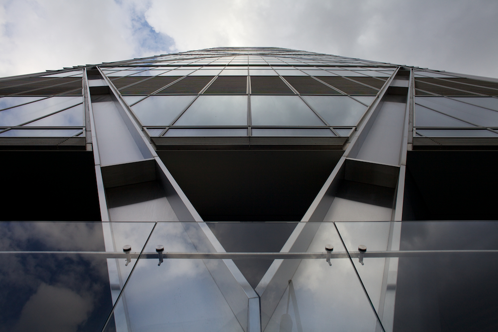 A sleek modern building with glass and steel architecture, highlighting innovative co-working spaces in Shoreditch.