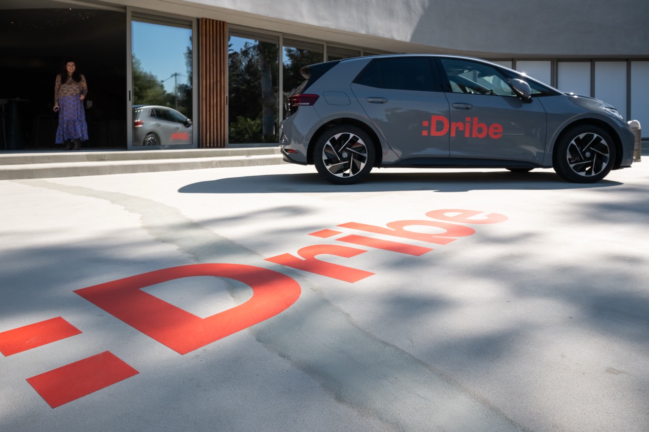 A sleek electric car with the “:Dribe” logo, representing innovation and the future of mobility in the UK.