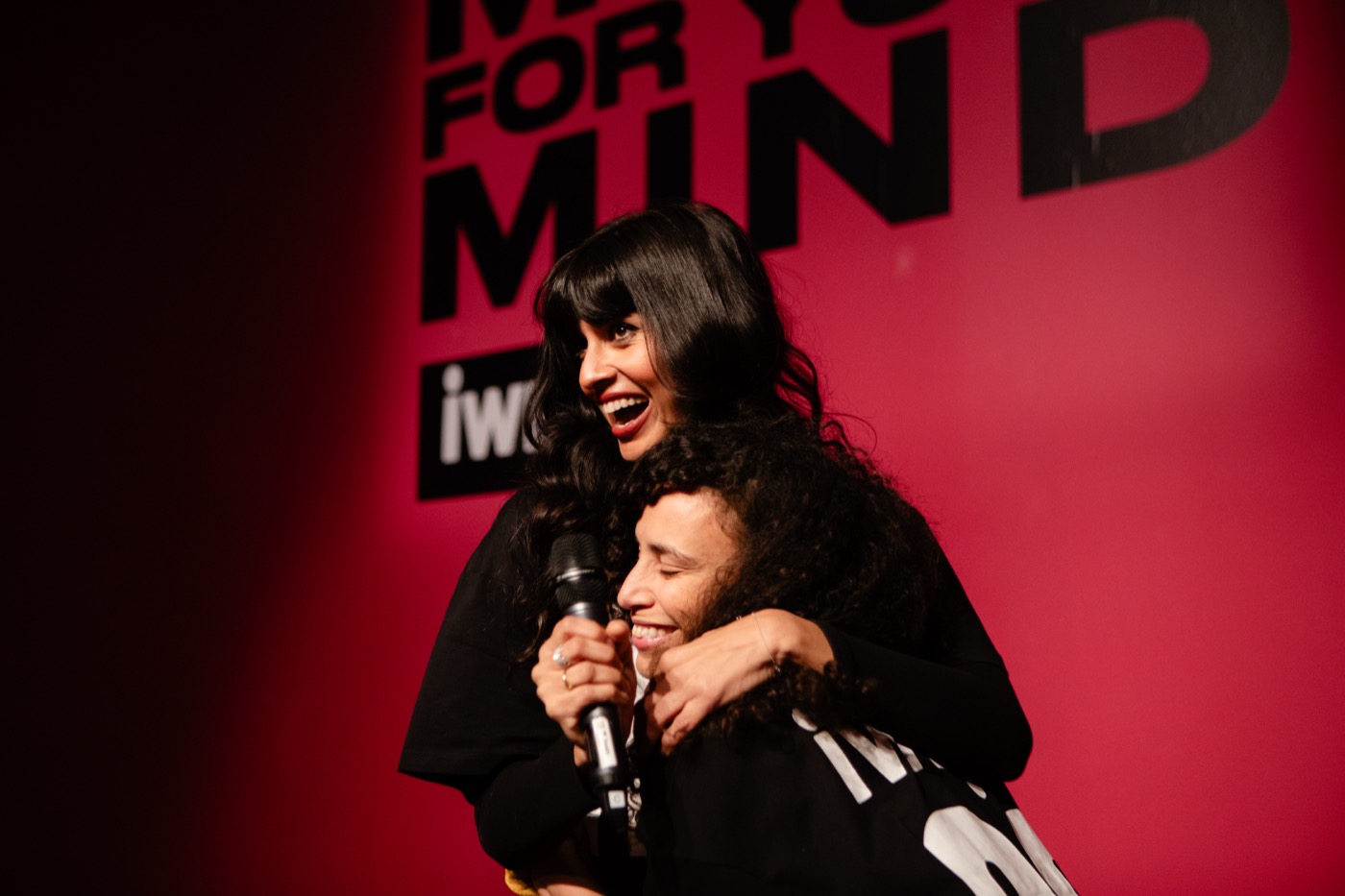 Jameela Jamil embraces a fellow participant on stage at the ‘Move For Your Mind’ Festival, radiating joy and connection.