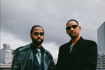 Will Smith and Big Sean standing on the rooftop in a Matrix inspired pose.