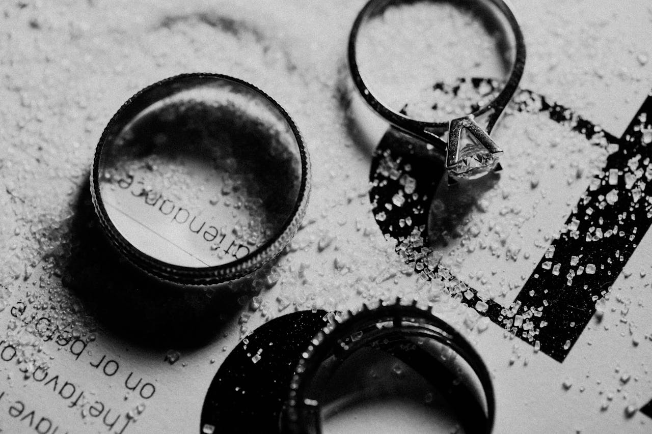 Close-up of elegant silver rings scattered with granulated details, highlighting the craftsmanship of jewellery in London.