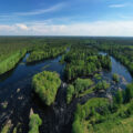 Aerial view of lush green landscapes and winding rivers in Oulu, showcasing the natural beauty of Oulu2026 European Capital of Culture.