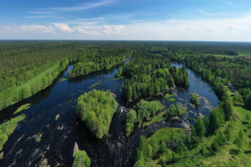 Aerial view of lush green landscapes and winding rivers in Oulu, showcasing the natural beauty of Oulu2026 European Capital of Culture.