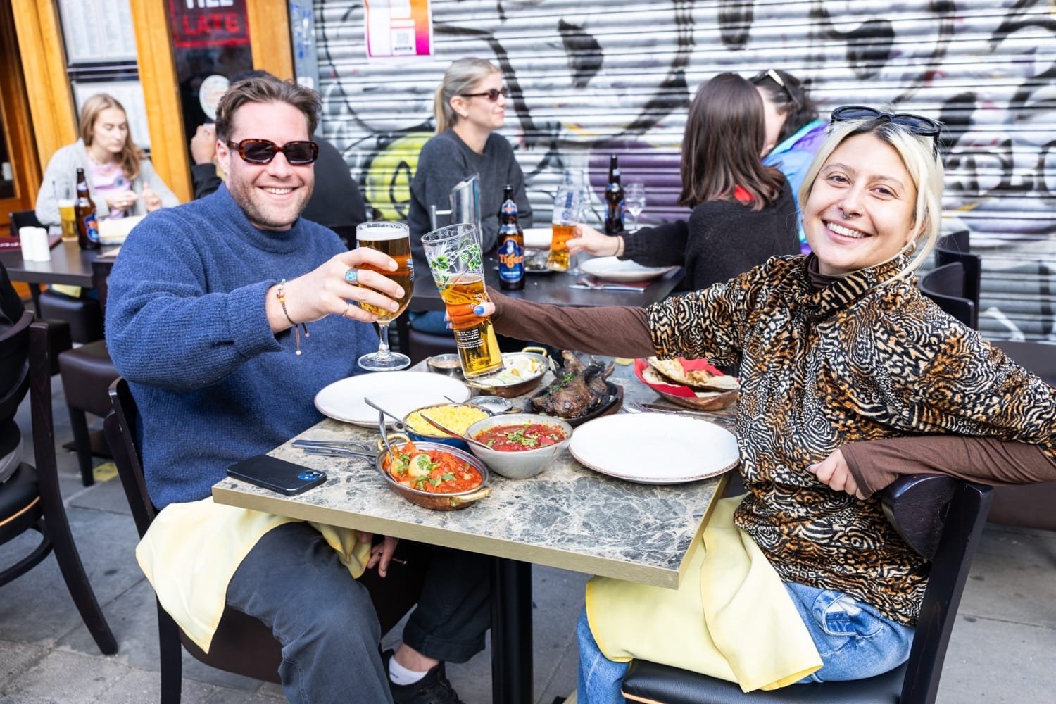 Brick Lane Curry Festival Brings Over 22,500 People Together to Celebrate East London’s Diversity 7 people enjoying cury at Brick Lane Curry Festival