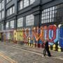 Shoreditch Residents Increasingly Turn to Crypto for Everyday Purchases 1 Colourful Shoreditch street art with person walking by