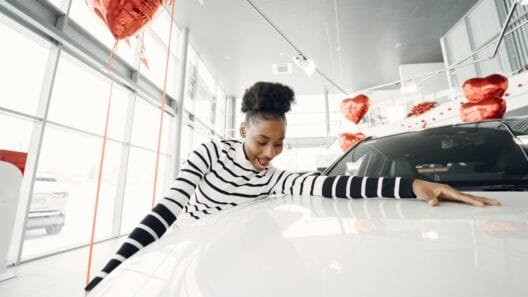 Driver reviewing car to improve chances of car finance approval