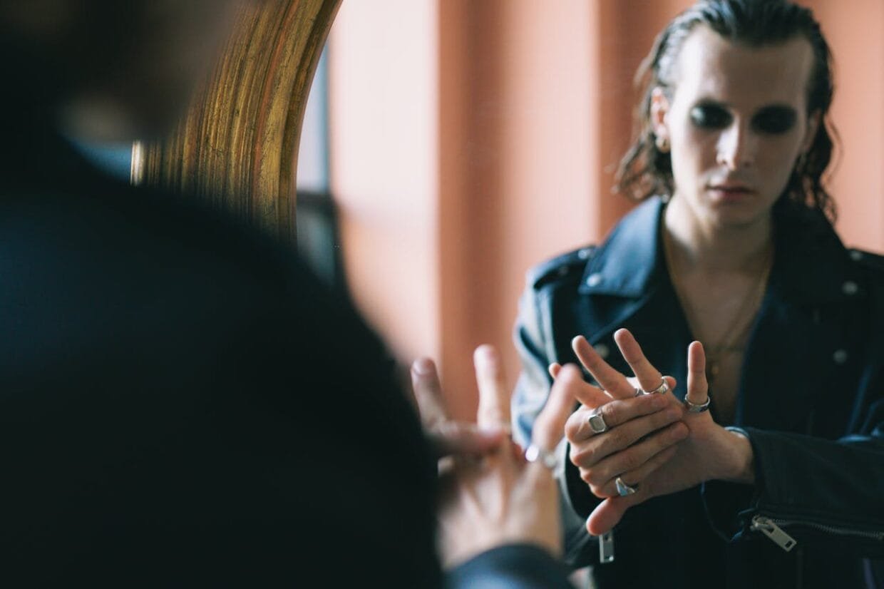 Man wearing layered Tokyo men’s jewellery styling inspired by Harajuku street fashion