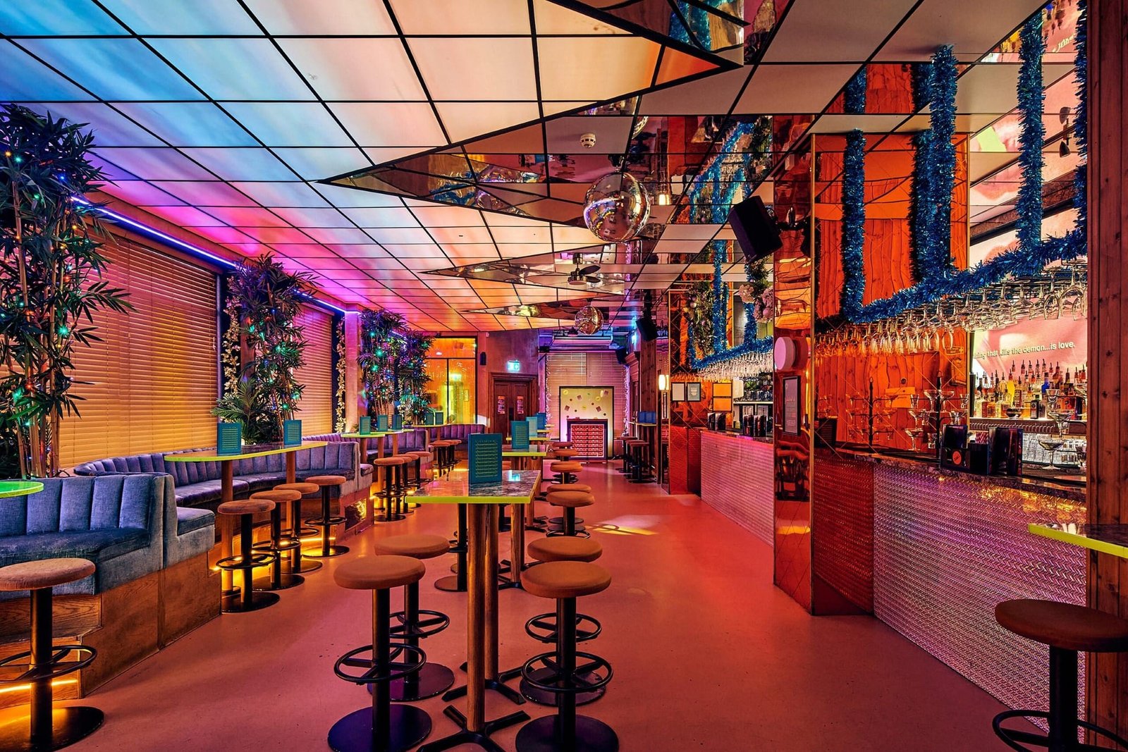 Nikki’s Bar in Shoreditch with bold neon lights, playful décor, and cheeky cocktails in a retro party setting