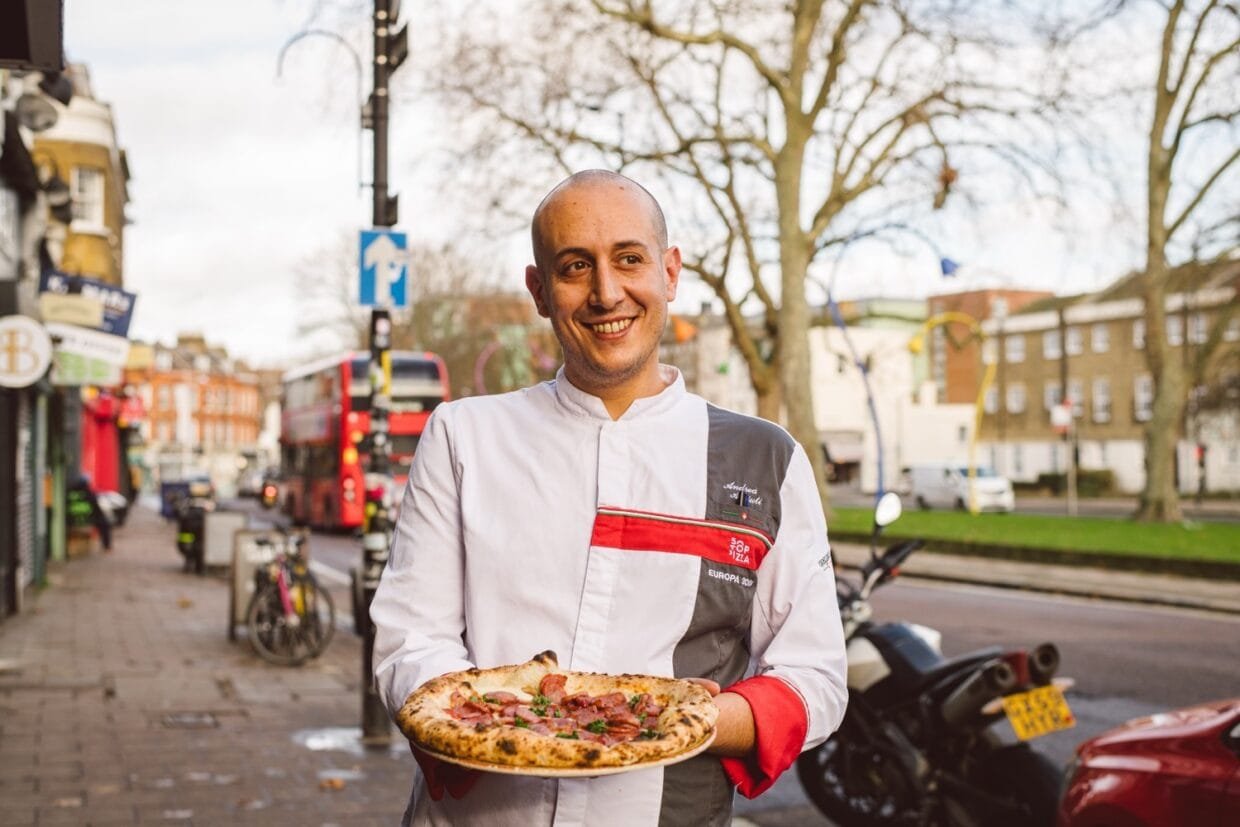 Meet Andrea Asciuti: The Pizza Innovator Behind '081 Pizzeria' Redefining Neapolitan Craft in London 6 Andrea Asciuti holding Neapolitan pizza in front of 081 Pizzeria