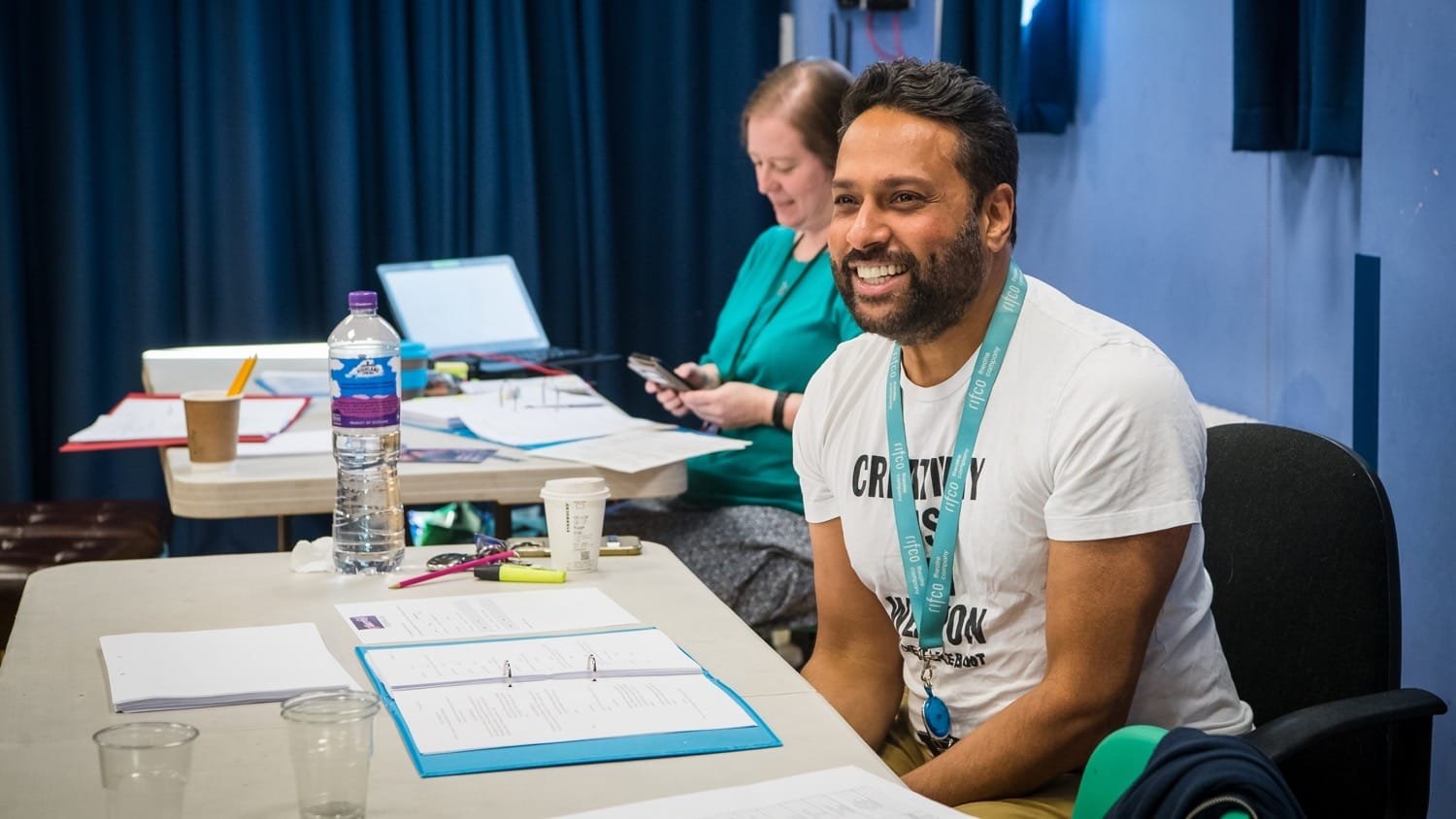 Pravesh Kumar MBE speaking inside Hampton Court Palace during rehearsals meeting