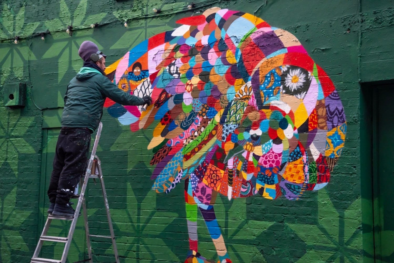 Louis Michel painting the Shoreditch turkey mural during the Viva! collaboration