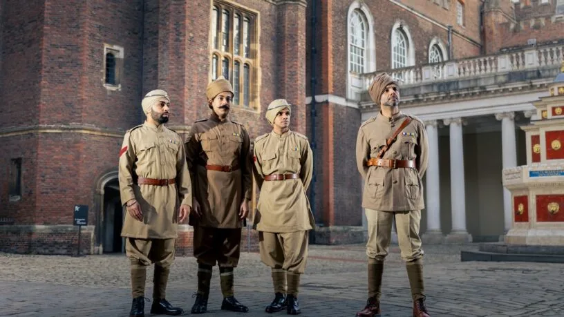 Cast performing The Indian Army at the Palace with marigold pins