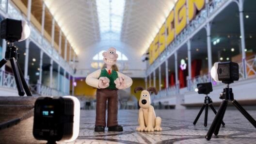 Display of Aardman clay models from the Wallace & Gromit exhibition showing character sketches and handcrafted puppets.