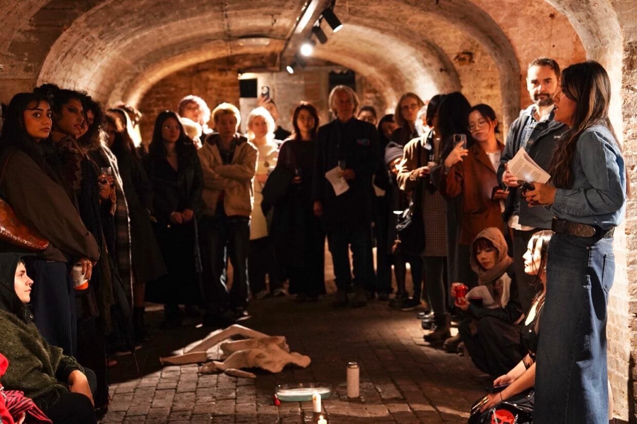 Inside Wenqi Zhang’s Vision for Which Witch Collective 6 Portrait of curator Wenqi Zhang in a gallery setting among people