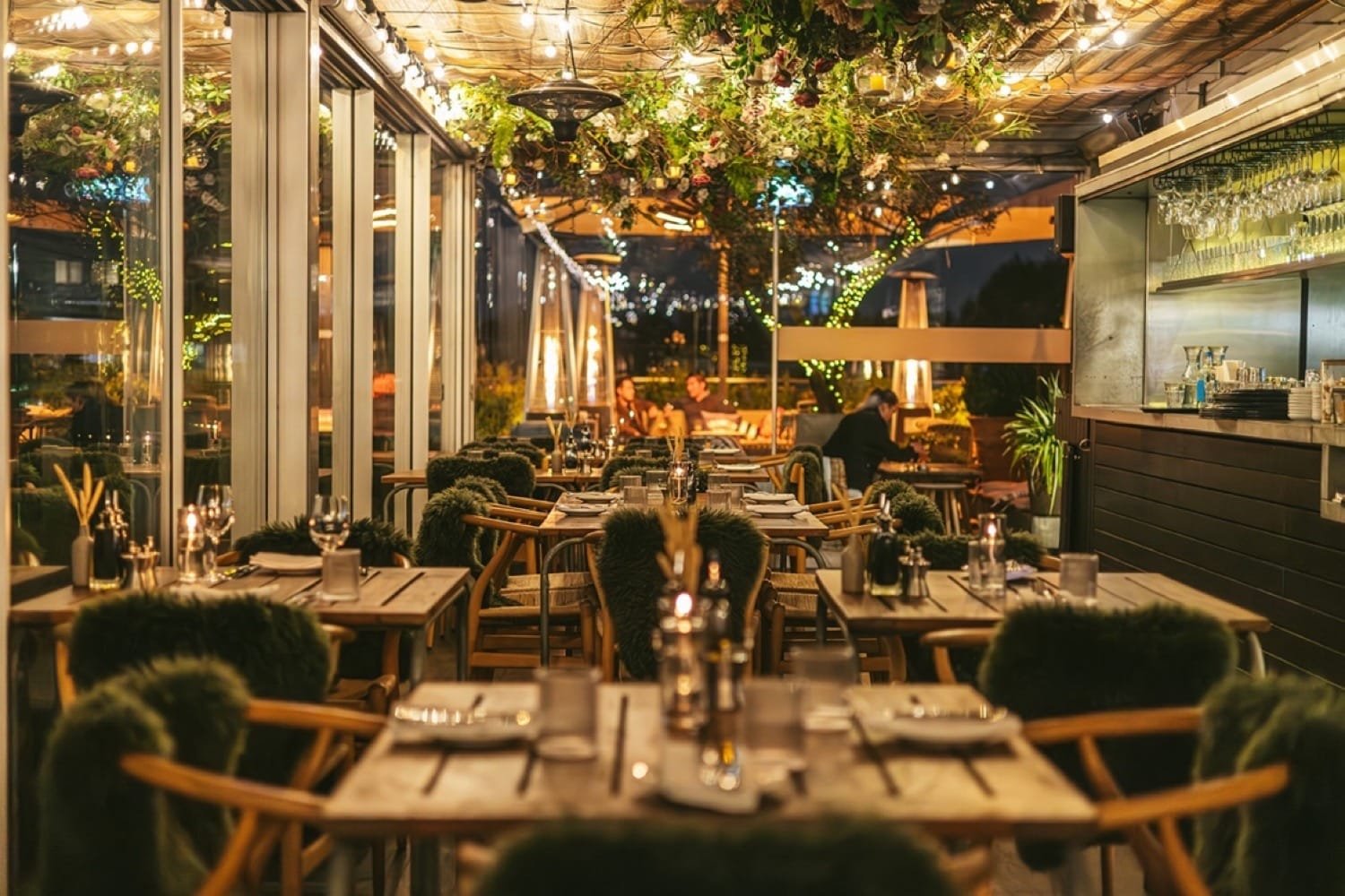 Cozy seating area at the Boundary Shoreditch rooftop with Alpine decor and warm lighting.
