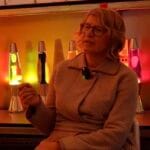 Cressida Granger, CEO of Mathmos, standing with an iconic lava lamp