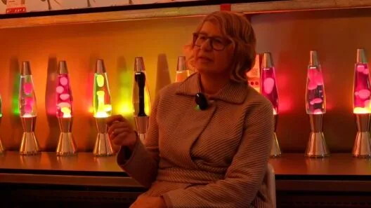 Cressida Granger, CEO of Mathmos, standing with an iconic lava lamp