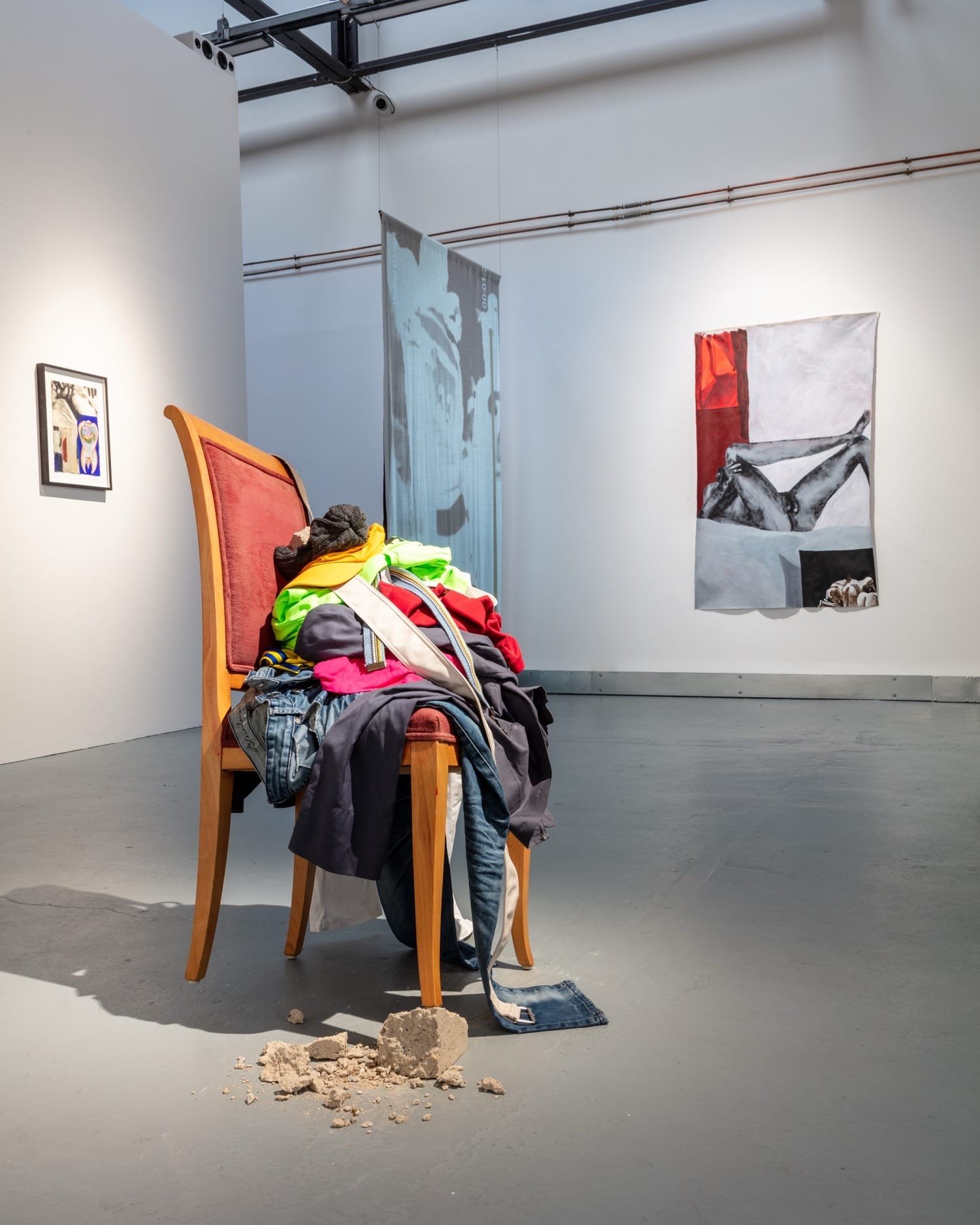 Sculptural elements featuring folded garments in the immersive exhibition.