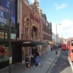 The Hackney Empire theatre on Mare Street with a red bus passing