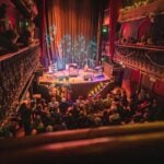 The two-tier galleried auditorium of Hoxton Hall on Hoxton Street, lit for a concert