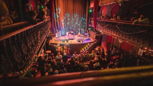 The two-tier galleried auditorium of Hoxton Hall on Hoxton Street, lit for a concert