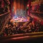 The two-tier galleried auditorium of Hoxton Hall on Hoxton Street, lit for a concert