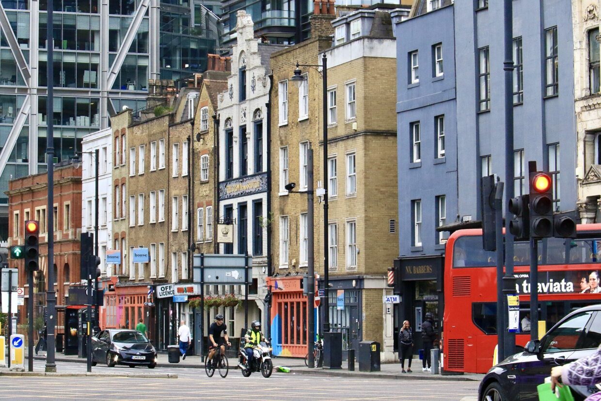 Shops and a red bus on Shoreditch High Street, London