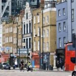 Shops and a red bus on Shoreditch High Street, London