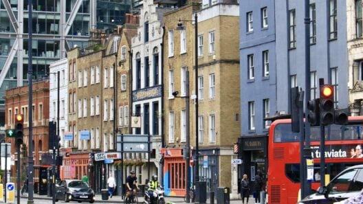 Shops and a red bus on Shoreditch High Street, London
