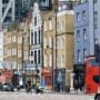 Shops and a red bus on Shoreditch High Street, London