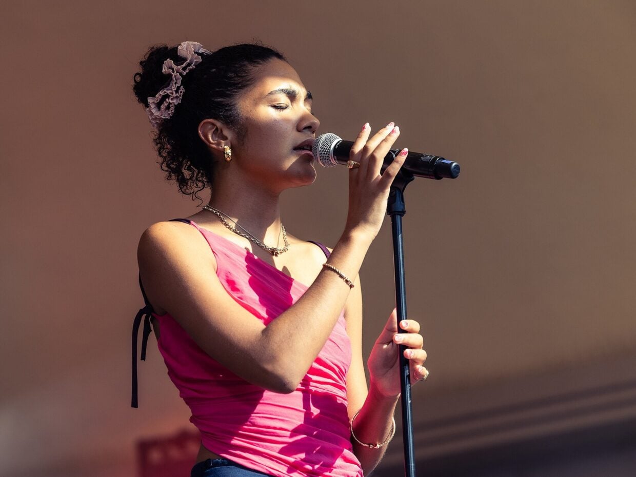 Olivia Dean performing on stage