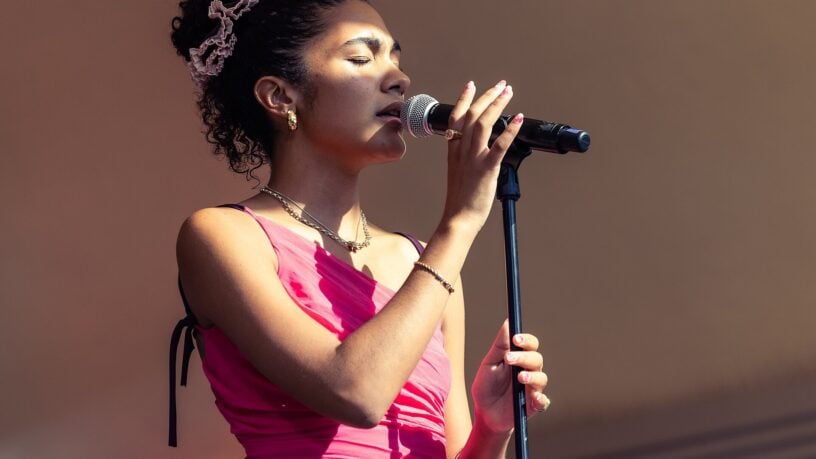 Olivia Dean performing on stage